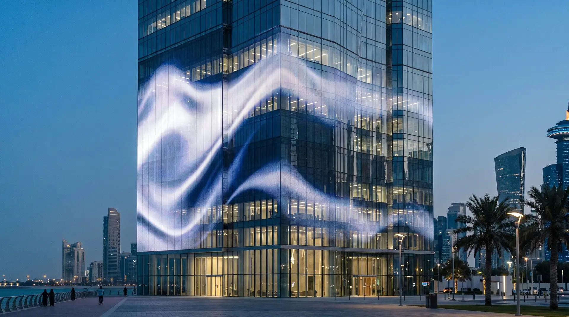 Transparent LED mesh facade on a glass building at blue hour
